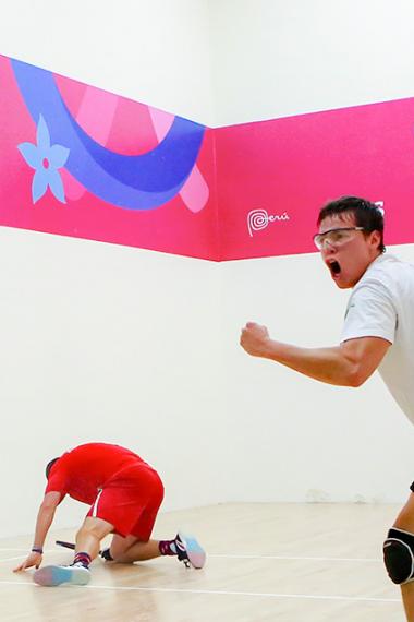 Bolivian Carlos Keller celebrates his victory over American Jacob Bredenbeck, who laid on the floor during the Lima 2019 racquetball semifinals at the Callao Regional Sports Village. 