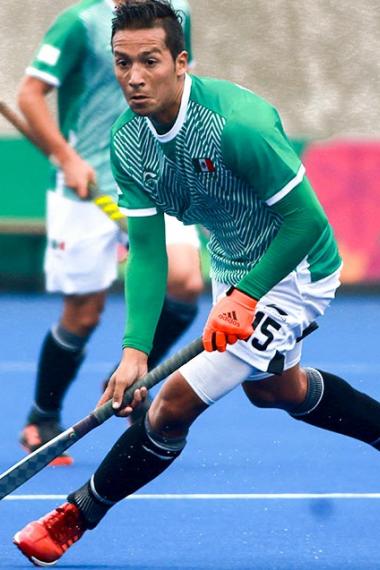 Mexican Francisco Aguilar pushing the ball during hockey match against Peru, held at the Villa María del Triunfo Sports Center at Lima 2019 