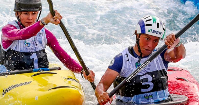 Paddler trying to overtake her opponent in an extreme canoe slalom championship. 
