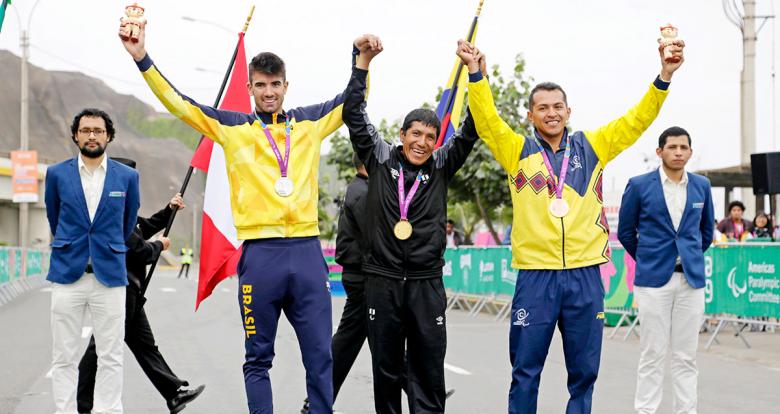 Para cyclists Hilario Rimas from Peru (gold), Lauro Moro from Brazil (silver) and Diego Dueñas from Colombia (bronze) proudly pose on the podium of the Lima 2019 men’s C1-2 time trial competition at Costa Verde in San Miguel