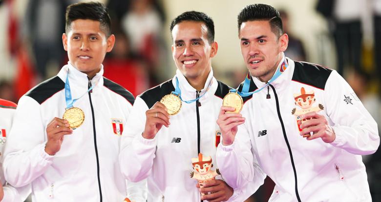 Peruvians Jhon Trebejo, Oliver del Castillo, and Carlos Lam celebrate the gold achieved in Lima 2019 team karate kata event after beating their Mexican counterparts at the Villa El Salvador Sports Center