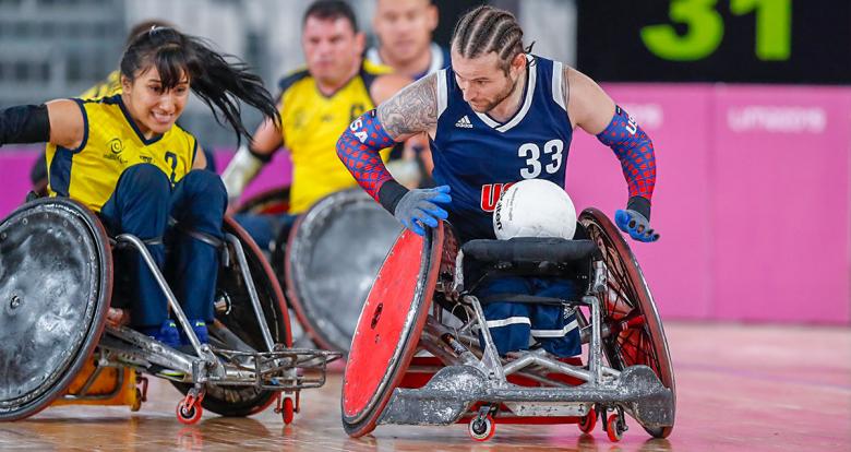 American Raymond Hennagir III and Colombian Paola Martinez fight for the ball in the Lima 2019 wheelchair rugby match at the Villa El Salvador Sports Center