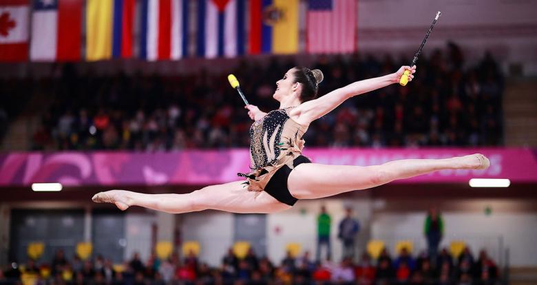 Canadian gymnast Natalie Garcia extending her arms and performing an amazing pirouette at the Villa El Salvador Sports Center in the Lima 2019 Games