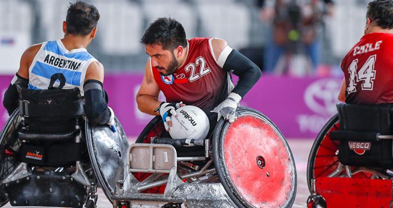 Chilean Francisco Cayulef controls the ball in the Lima 2019 wheelchair rugby match against Argentina at the Villa El Salvador Sports Center