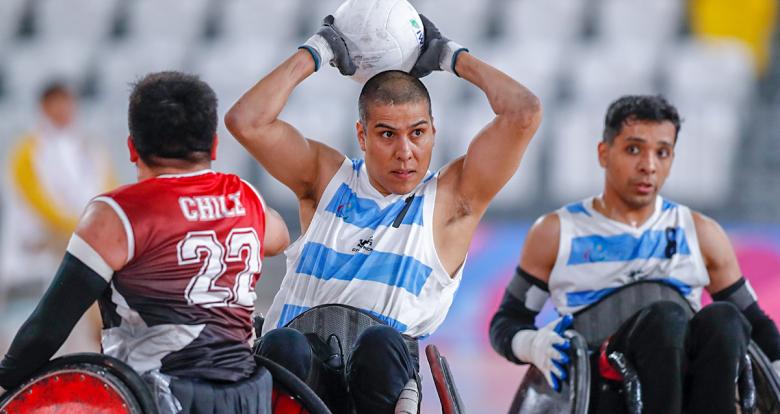Argentinian Matías Cardozo and Chilean Francisco Cayulef fight for the ball in the Lima 2019 wheelchair rugby match at the Villa El Salvador Sports Center