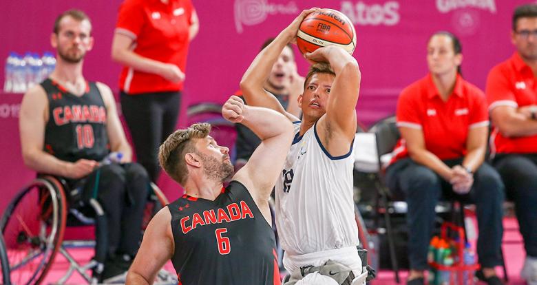 Colombian Jhon Hernandez tries to defend the ball from Canadian Robert Hedges during a wheelchair basketball game at the National Sports Village – VIDENA, at Lima 2019