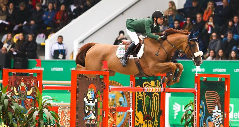 Marlon Zanotelli of Brazil jumps over bars in the Lima 2019 jumping competition at the Army Equestrian School