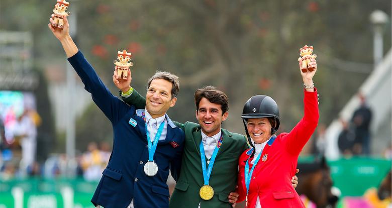 José María Larocca of Argentina (silver), Marlon Zanotelli of Brazil (gold) and Elizabeth Madden of the United States (bronze) proudly posing with their medals and cuchimilco presents after winning in the Lima 2019 jumping event at the Army Equestrian School