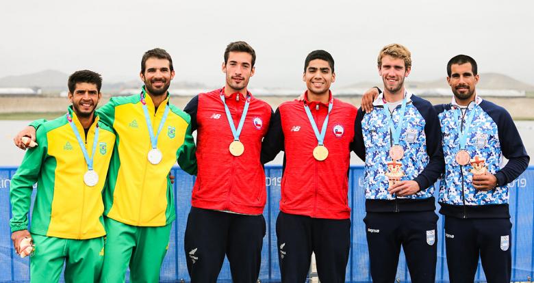 Brazil (silver), Chile (gold) and Argentina (bronze) proudly showing their medals after the Lima 2019 Games coxless pairs competition at Albufera Medio Mundo – Huacho