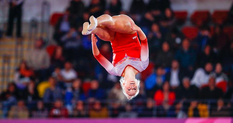American gymnast Nicole Ahsinger performing somersaults at the Villa El Salvador Sports Center and taking home silver at Lima 2019