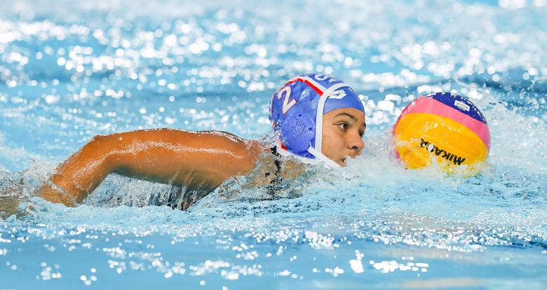 Cuban Dalia Grau facing off Puerto Rico in Lima 2019 water polo competition at Villa Maria del Triunfo Sports Center.