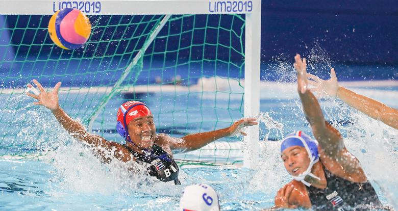 Cuban and Puerto Rican athletes facing off during Lima 2019 water polo competition at the Villa Maria del Triunfo Sports Center.