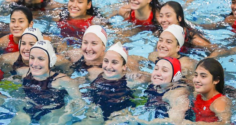 Team USA smiling with their Peruvian counterparts after winning the Lima 2019 water polo competition at the Villa Maria del Triunfo Sports Center.