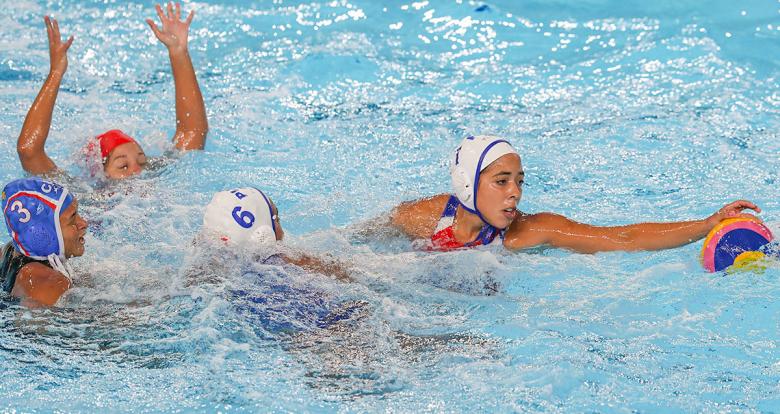 Puerto Rico’s Nathalia Melendez and Sabrina Estevez trying to catch the ball during Lima 2019 water polo competition at the Villa Maria del Triunfo Sports Center.