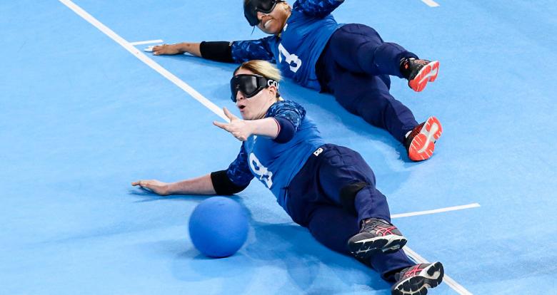 Ana Custodio and Gabrielly Assuncao from Brazil dive to catch the ball in the Lima 2019 goalball match against Mexico at the Callao Regional Sports Village