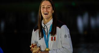 Natalia Cuglievan with her gold medal in water ski trick event