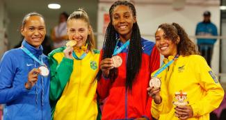 Paige Pherson, Milena Titoneli, Acosta and Katherine Dumar show their silver, gold and bronze medals, respectively