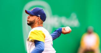 Baseball player Jose Calero about to throw the ball in the victory against Cuba at the Villa María del Triunfo venue, Lima 2019 