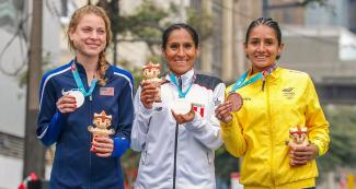 Winners of the women’s marathon show their medals and presents 