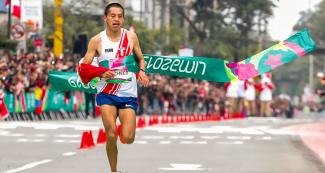 Christian Pacheco crosses the finish line in men’s marathon