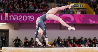 Elsabeth Black performs a turn on the balance beam at Lima 2019 