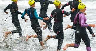 Group of athletes start triathlon competition at Chorrillos Beach