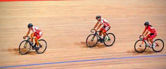 Cyclists facing off during a track cycling event. 
