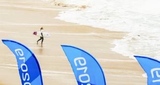 Surfer Lucia Indurian from Argentina entering the sea at women’s Open 