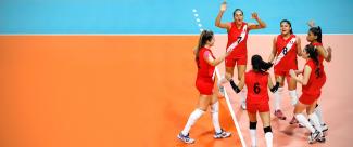 Peruvian national team celebrates scoring a point during a volleyball championship.