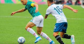 Ismael Goveal (Mexico) and Agustín Urzi (Argentina) face off in a football match played at the stadium of the National University of San Marcos, at the Lima 2019 Pan American Games