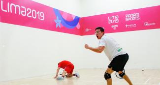 Bolivian Carlos Keller celebrates his victory over American Jacob Bredenbeck, who laid on the floor during the Lima 2019 racquetball semifinals at the Callao Regional Sports Village. 