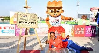 Cuban Para athlete Omara Durand poses next to the plaque of honor at the National Sports Village - VIDENA