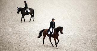 Two riders on their horses during the Lima 2019 dressage event, held at the Army Equestrian School