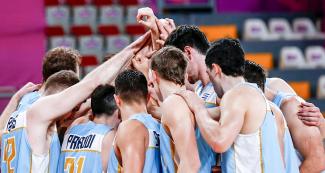The Uruguayan basketball team celebrates after the competition against the Dominican Republic held at the Eduardo Dibós Coliseum at the Lima 2019 Pan American Games