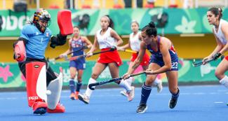 American and Peruvian hockey players face off in a challenging game at Villa María del Triunfo Sports Center at the Lima 2019 Games.