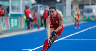 Chilean hockey team player Denise Krimerman faces off Mexico at Villa María del Triunfo Sports Center at the Lima 2019 Games.