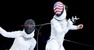 Canadian Jessica Guo dodges American Lee Kiefer during the women’s individual foil final at the Lima Convention Center
