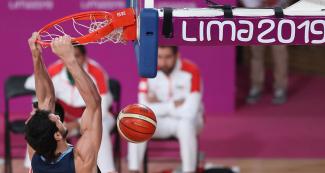 The Argentinian player Tayavek Gallizi scores against Mexico during basketball match