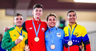 Douglas Brose from Brazil, Joaquín González from Chile, Maximiliano Larrosa from Uruguay and Jovanny Martinez from Venezuela show the medals they won in the Lima 2019 Games karate competition, at the Villa María del Triunfo Sports Center.