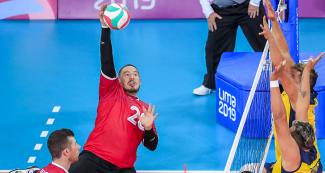 Canadian Jesse Buckingham returns the ball to Colombia in Lima 2019 sitting volleyball match against Canada held at the Callao Regional Sports Village