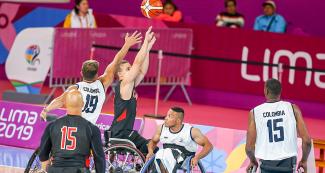 Colombian Jhon Hernandez fights for the ball against Canadian Robert Hedges during a wheelchair basketball game at the National Sports Village – VIDENA, at Lima 2019