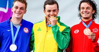 Canada’s Keenan Simpson (bronze), US’s Joshua Joseph (silver) and Brazil’s Pedro Goncalves (gold) show the medals earned in the men’s K1 extreme slalom in Río Cañete - Lunahuana