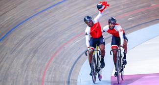 Nijisane Phillip hugs his compatriot Nicholas Paul from Trinidad and Tobago for getting gold in Lima 2019 sprint event at the National Sports Village (VIDENA)