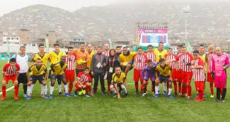 Peruvian and Colombian football 7-a-side teams pose for a photo together after the match at the Villa María del Triunfo Sports Center, at Lima 2019