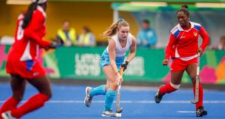 Hockey teams from Cuba and Uruguay fase off at the Lima 2019 Games in Villa Maria del Triunfo. 