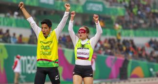 Mexican Para athlete Monica Rodriguez and her guide Kevin Teodoro Aguilar celebrate at the end of the women’s 1500m T11 competition at the National Sports Village – VIDENA at Lima 2019