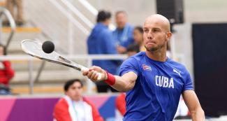 Cuba’s Alejandro Gonzales hits the ball in the match against Peru at the Villa María del Triunfo Sports Center during the Lima 2019 Games