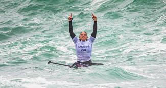 The Colombian Isabela Gomez gestures from her board in the women’s SUP surfing competition at the Lima 2019 Games, in Punta Rocas