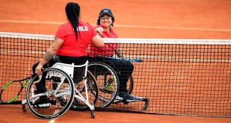 Peru’s Maria Castillo and Chile’s Sofia Fuentes share a smile after the Lima 2019 wheelchair tennis held at the Lawn Tennis Club