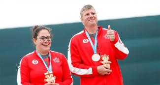 Amanda Chudoba and Curtis Wennberg smile after obtaining bronze medals in Shooting at the Lima 2019 Games, at Base Aérea Las Palmas